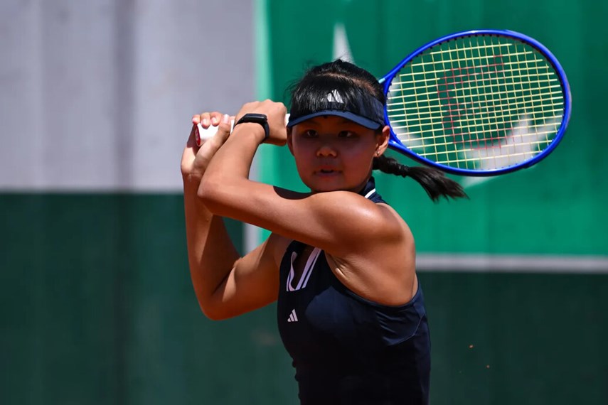 a woman holding a racket and a ball
