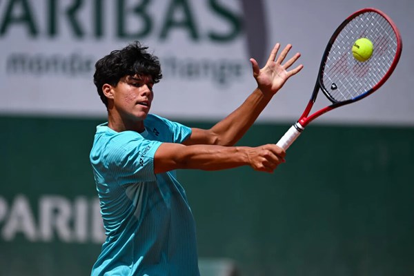 a person swinging a racket at a ball